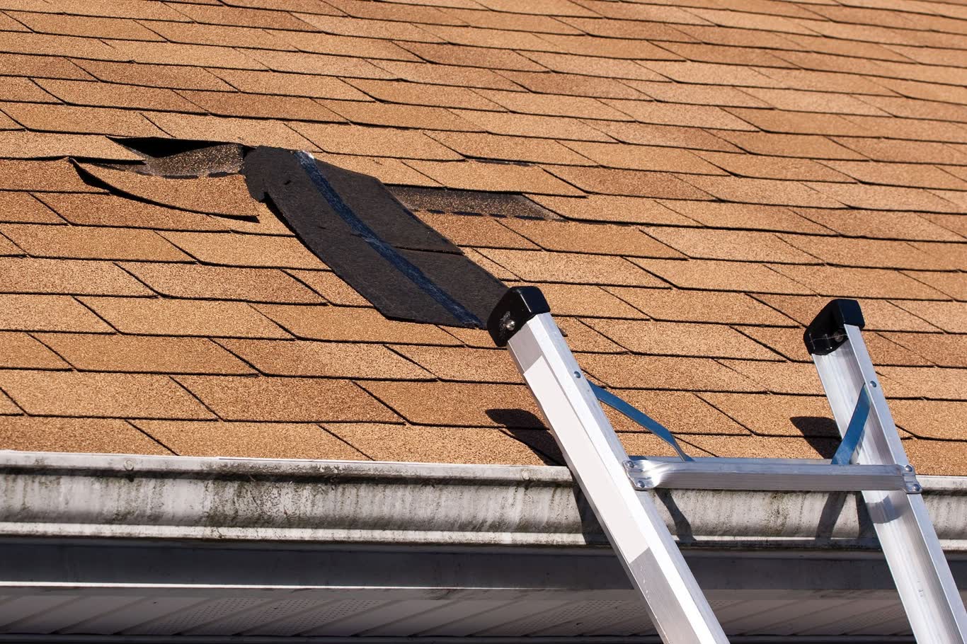 Roofer performing a leak repair