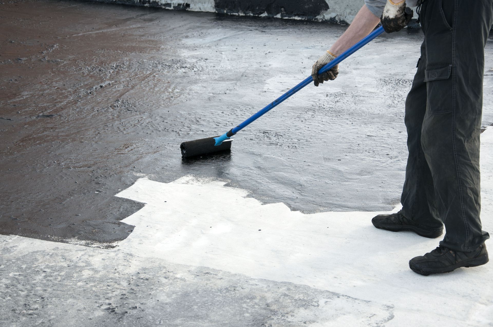 Roof coating application on commercial flat roof extending membrane life
